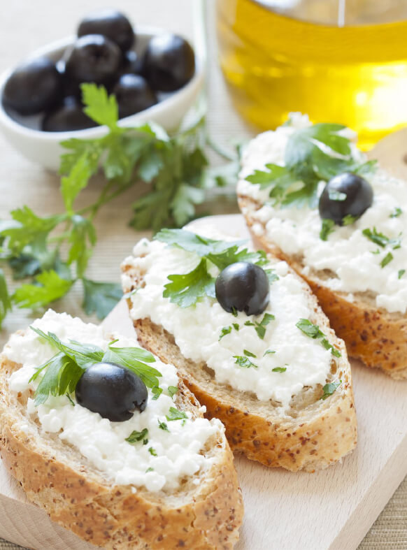 Penfield Olives food service and retail olives page pic, coriander, cottage cheese and kalamata olives on crusty bread.